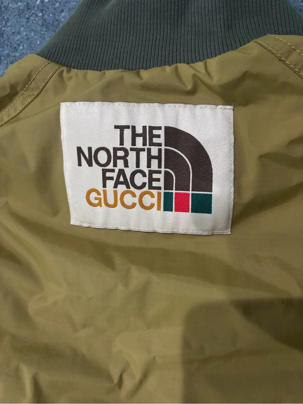 The North Face Olive Green Bomber Jacket with Logo Patch with garment bag & box